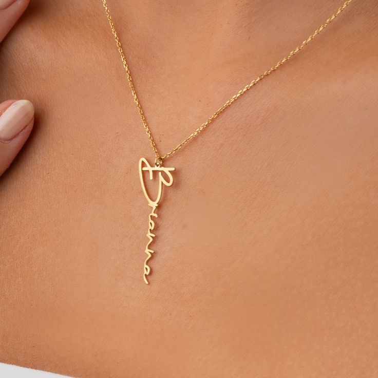 Close-up of personalized necklace featuring butterfly and heart charms