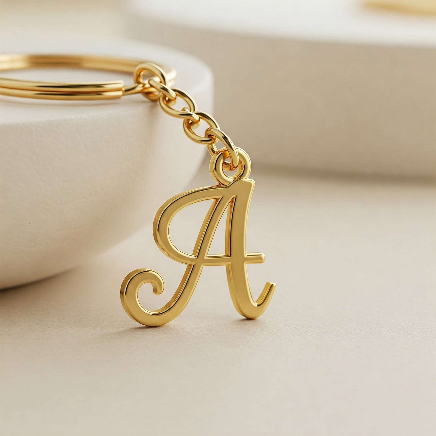 Hand holding custom single letter keychain, unique gift idea