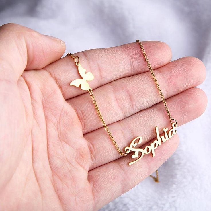 Butterfly and crown pendant necklace, displayed on white background