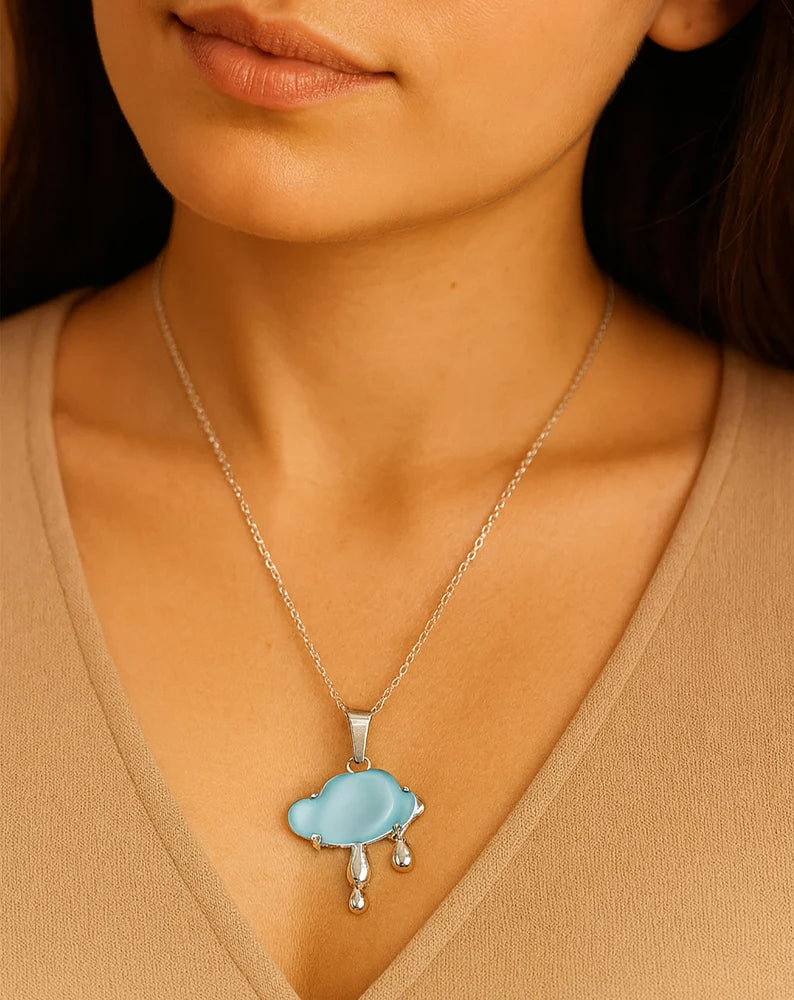Front view of silver-plated blue cloud pendant necklace on white background.