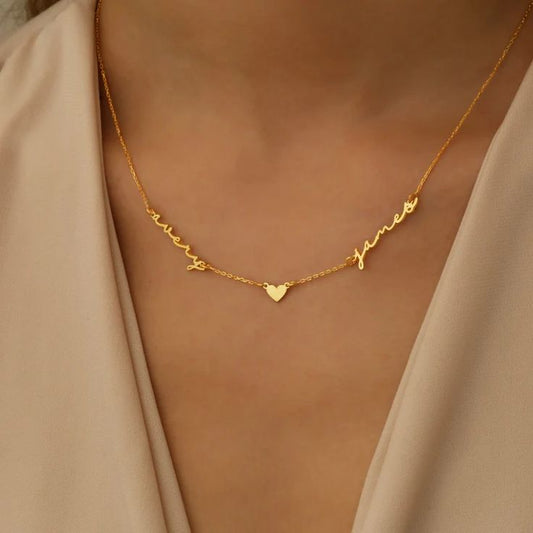 Personalized gold handwriting script necklace featuring two names and heart pendant