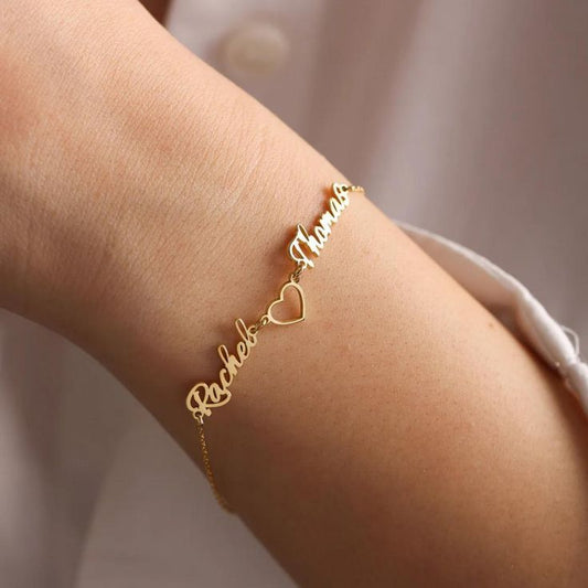 Close-up of custom love jewelry featuring heart charm with couple names engraving