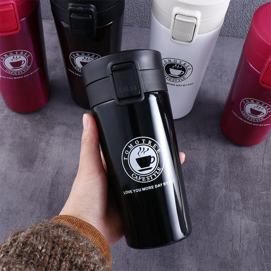Athlete holding a SeekSip personalized travel mug next to gym bag