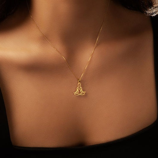 Close-up of zen meditation pendant necklace featuring lotus position figure